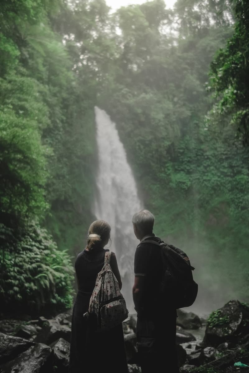 Couple enjoying an active lifestyle near a waterfall